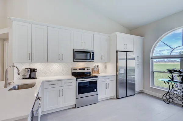 a kitchen with stainless steel appliances a stove a sink and a refrigerator