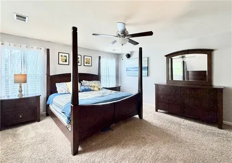 a living room with a bed and a dresser