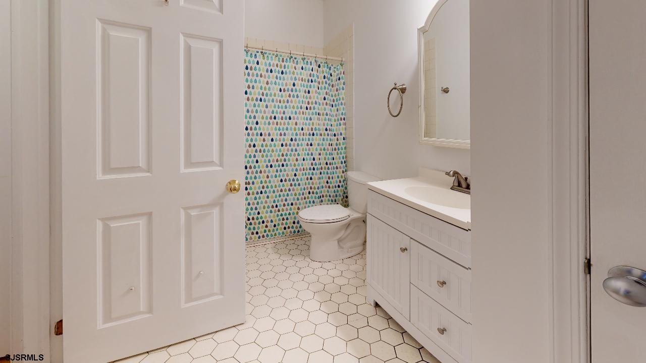 9 Edward Terrace Ocean View, NJ 08230 - Photo 18 of 30 a bathroom with a toilet sink and a mirror