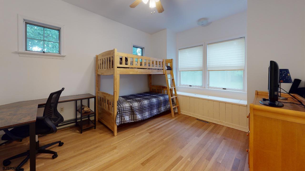 9 Edward Terrace Ocean View, NJ 08230 - Photo 20 of 30 a bedroom with a bed and a desk in it