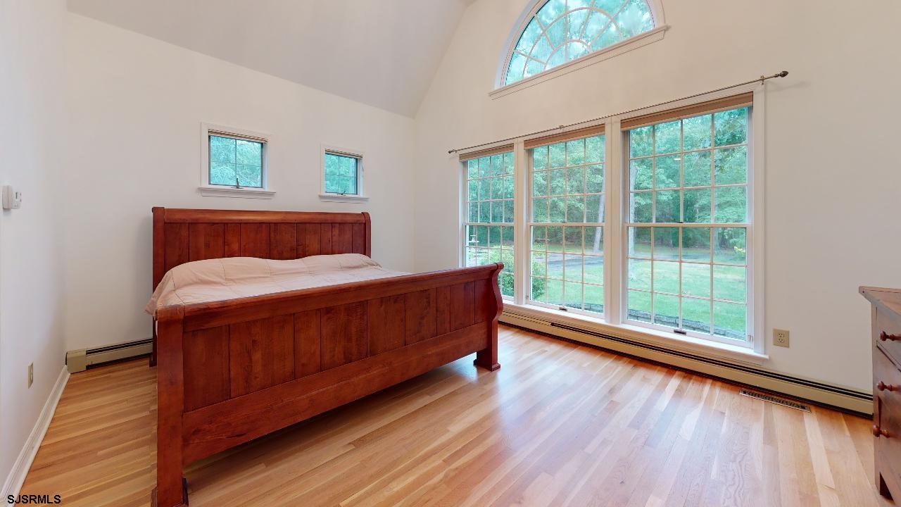 9 Edward Terrace Ocean View, NJ 08230 - Photo 23 of 30 a bedroom with a bed and a large window