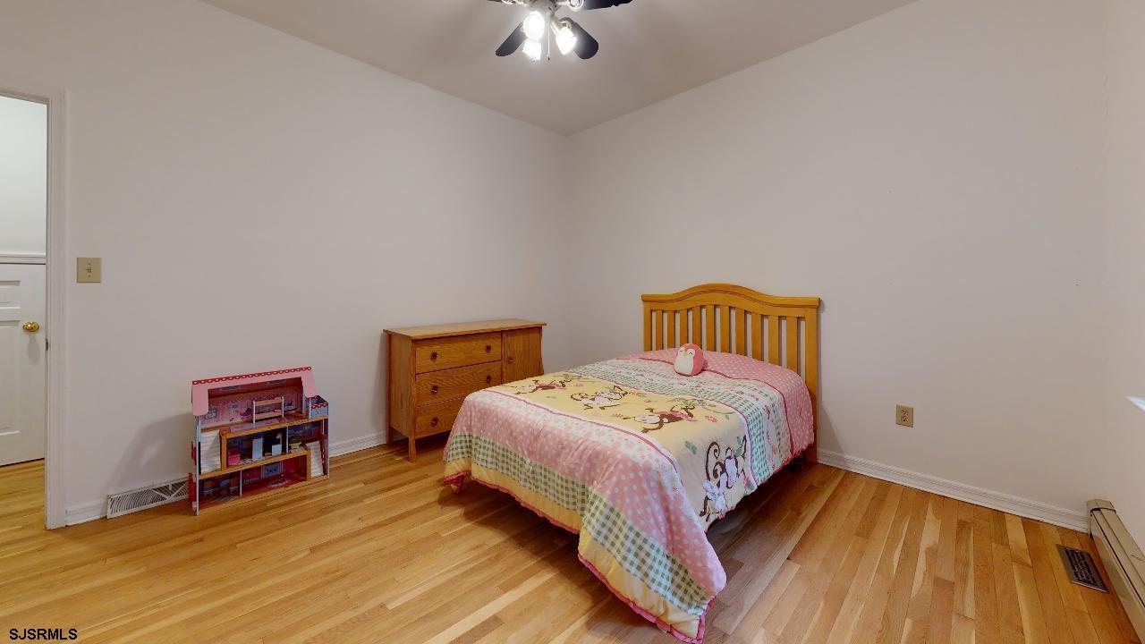 9 Edward Terrace Ocean View, NJ 08230 - Photo 27 of 30 a bedroom with a bed and a chandelier