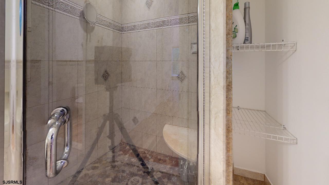 9 Edward Terrace Ocean View, NJ 08230 - Photo 29 of 30 a bathroom with a glass shower door