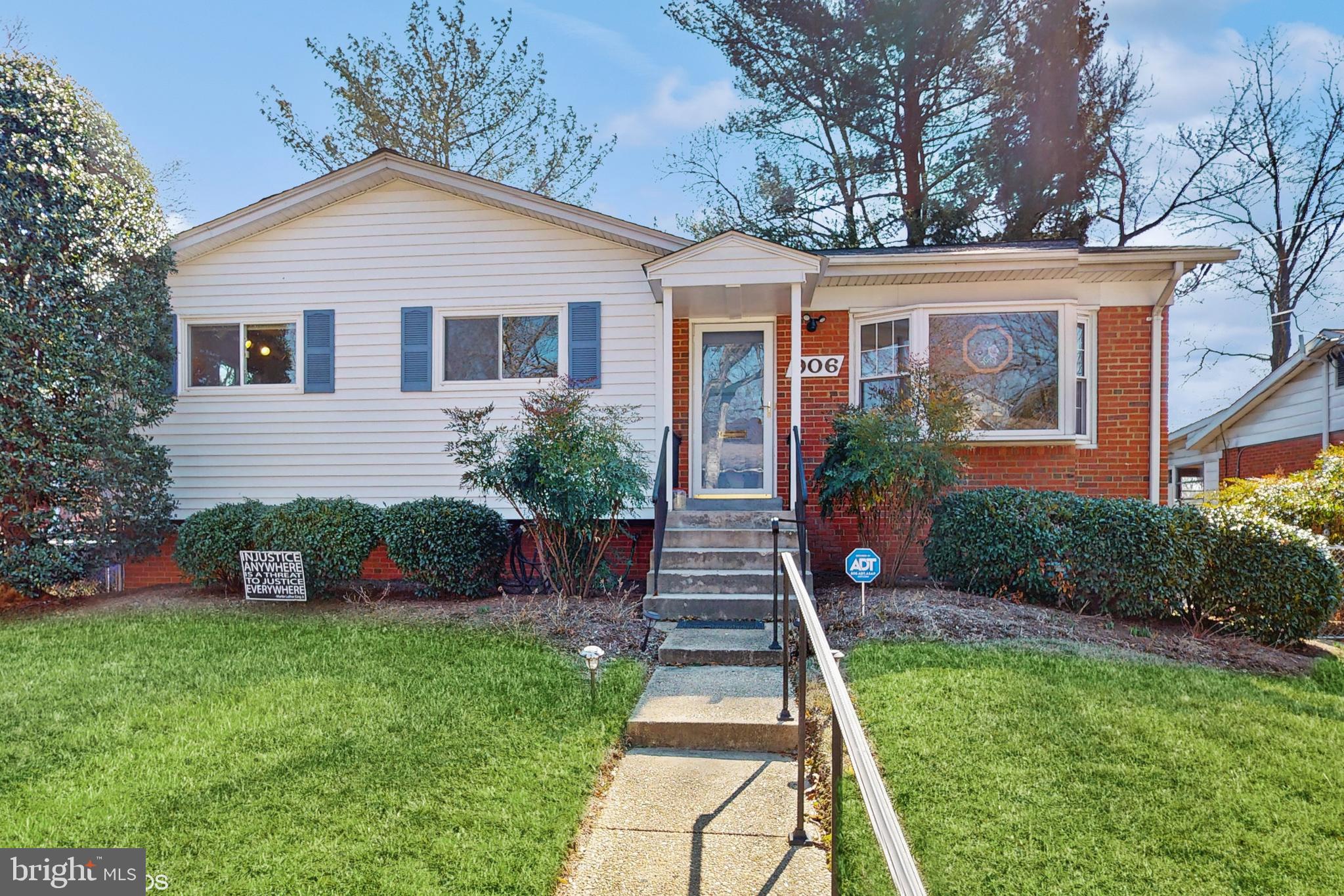 a front view of a house with a yard table and chairs