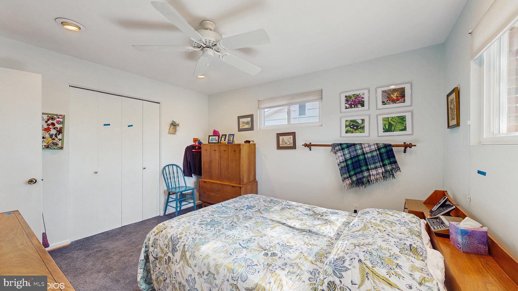 906 Malta Lane Silver Spring, MD 20901 - Photo 13 of 35 a bedroom with a bed and a dresser in it