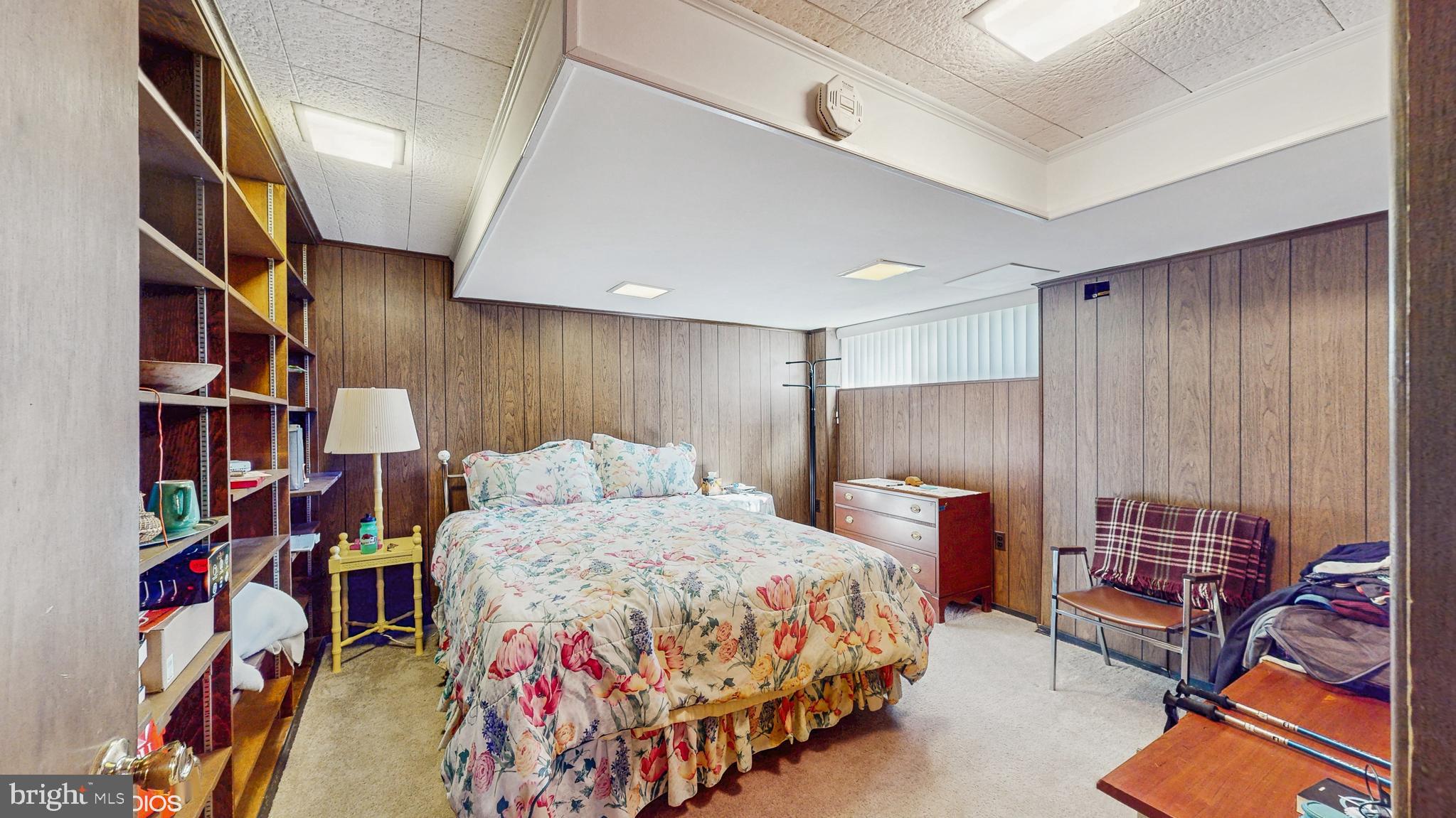 906 Malta Lane Silver Spring, MD 20901 - Photo 24 of 35 a bedroom with a bed and a book shelf