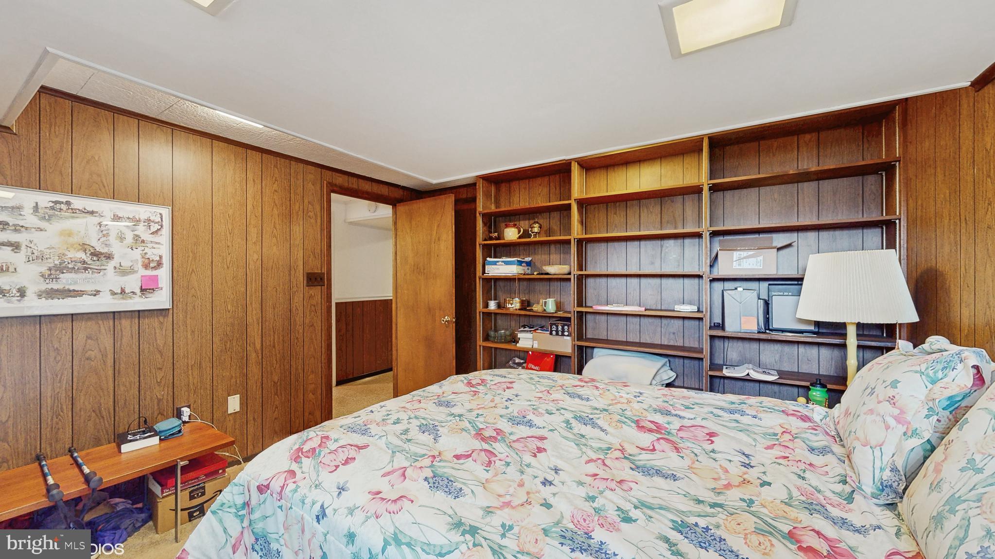 906 Malta Lane Silver Spring, MD 20901 - Photo 25 of 35 a bedroom with a bed a dresser and book shelf