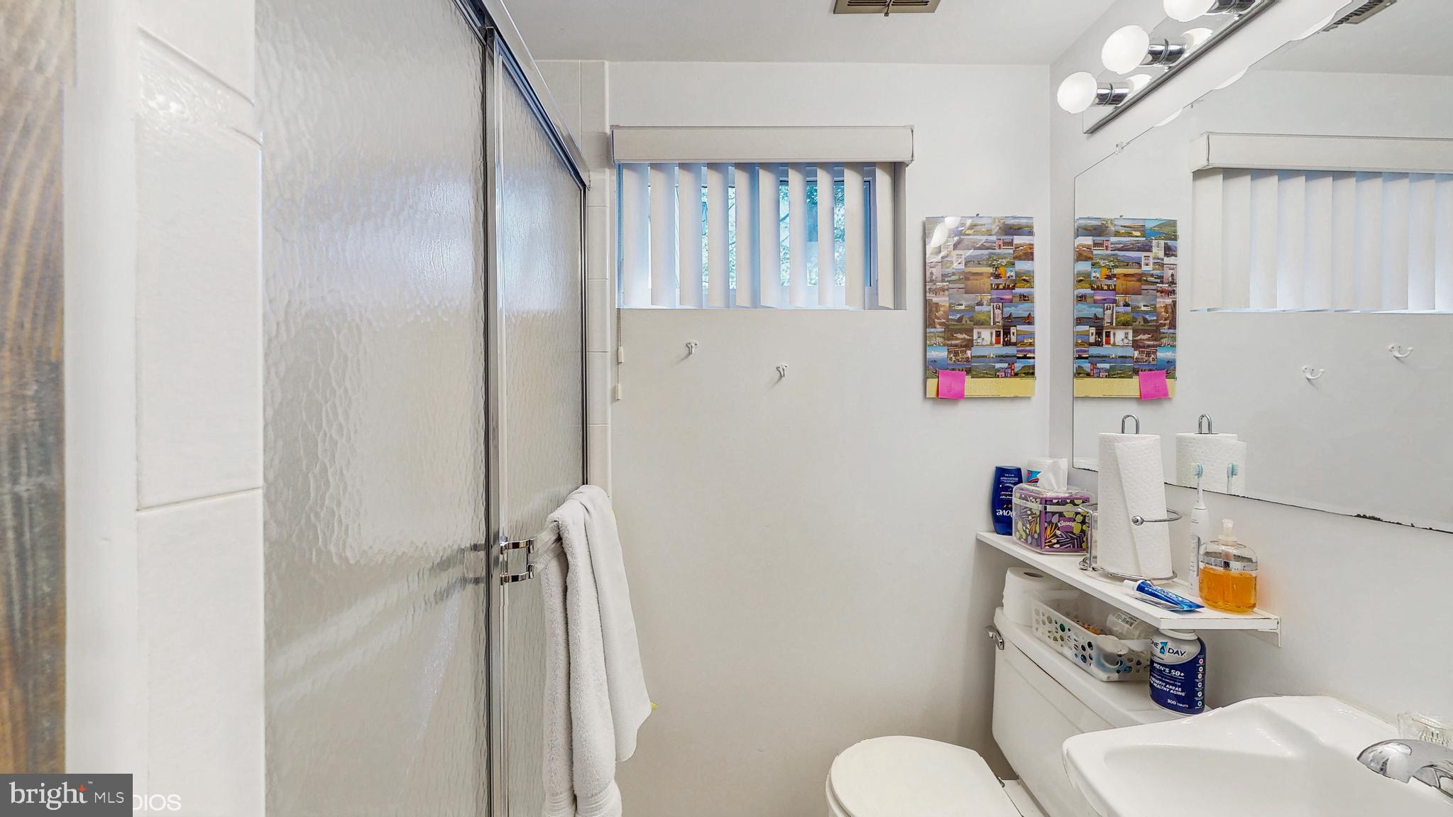906 Malta Lane Silver Spring, MD 20901 - Photo 26 of 35 a bathroom with a sink toilet vanity and tub