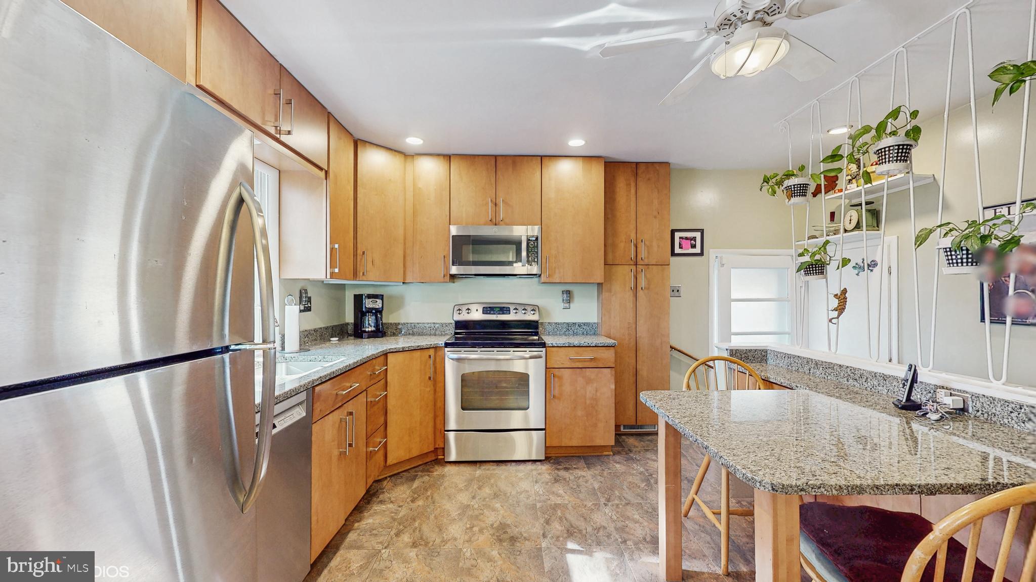 906 Malta Lane Silver Spring, MD 20901 - Photo 8 of 35 a kitchen with granite countertop a sink appliances and cabinets