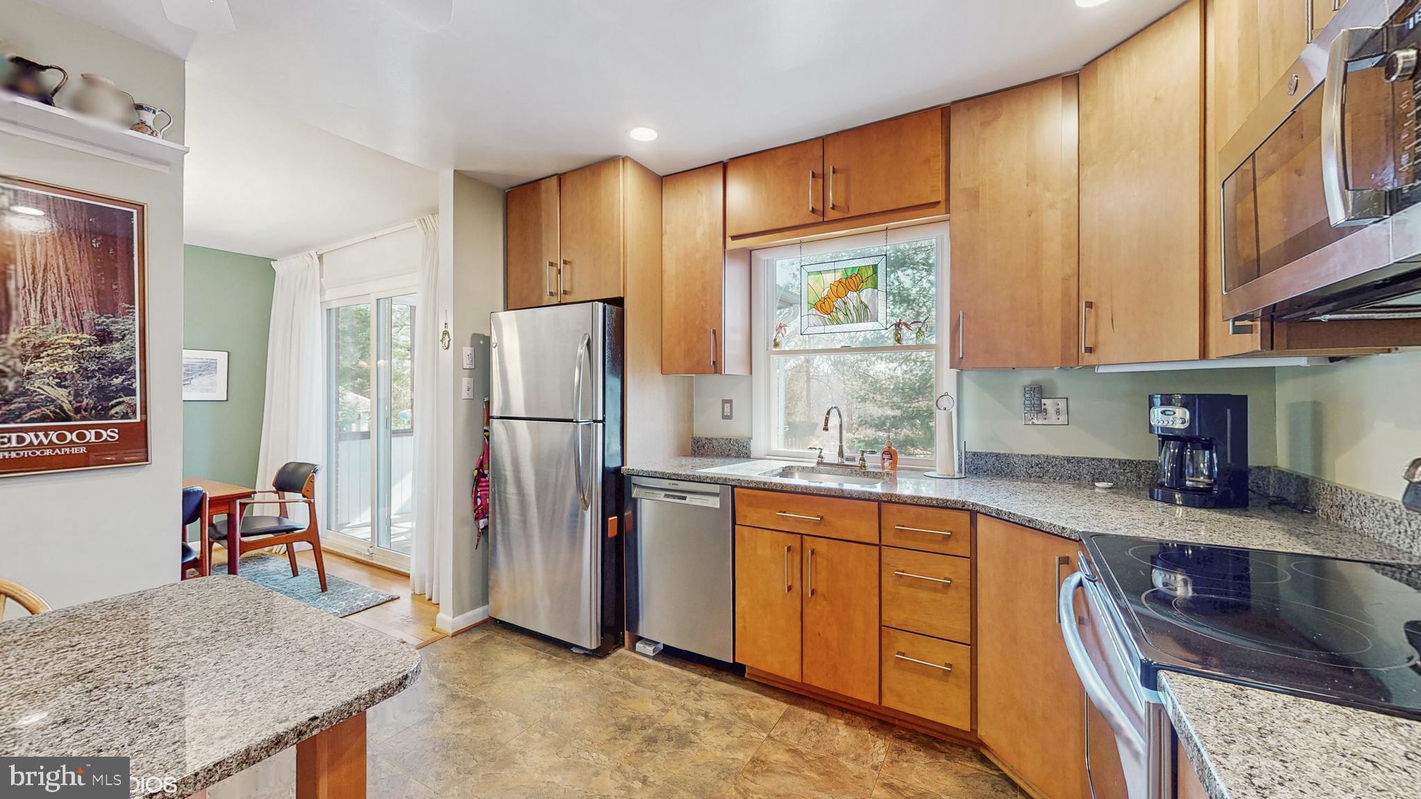 906 Malta Lane Silver Spring, MD 20901 - Photo 9 of 35 a kitchen with stainless steel appliances granite countertop a refrigerator and a stove top oven