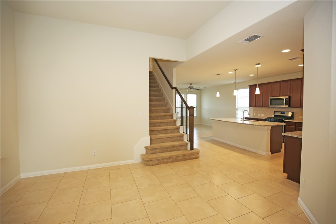 15912 Cessida Street Austin, TX 78728 - Photo 5 of 23 a view of kitchen with wooden floor and electronic appliances
