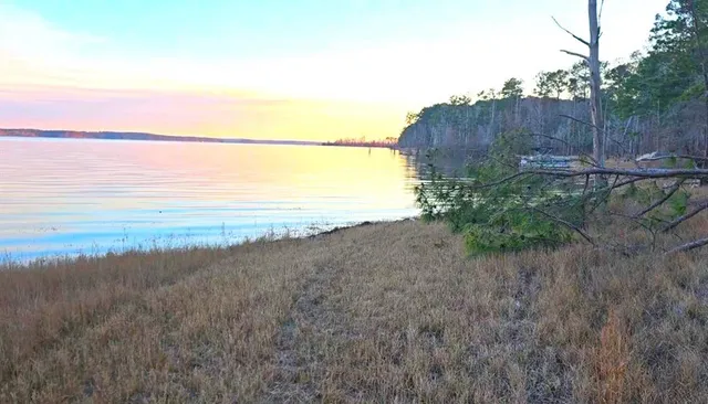 a view of a lake next to a yard