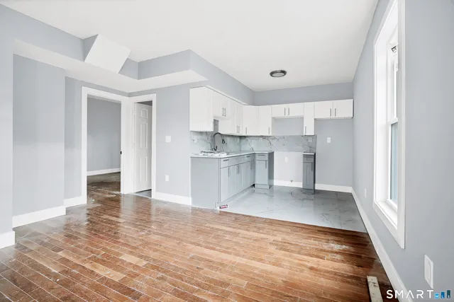 a view of a kitchen with electric appliances