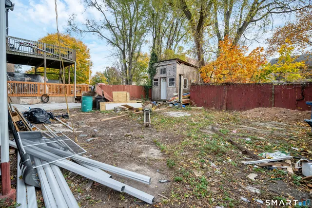 a view of a backyard with plants and trees