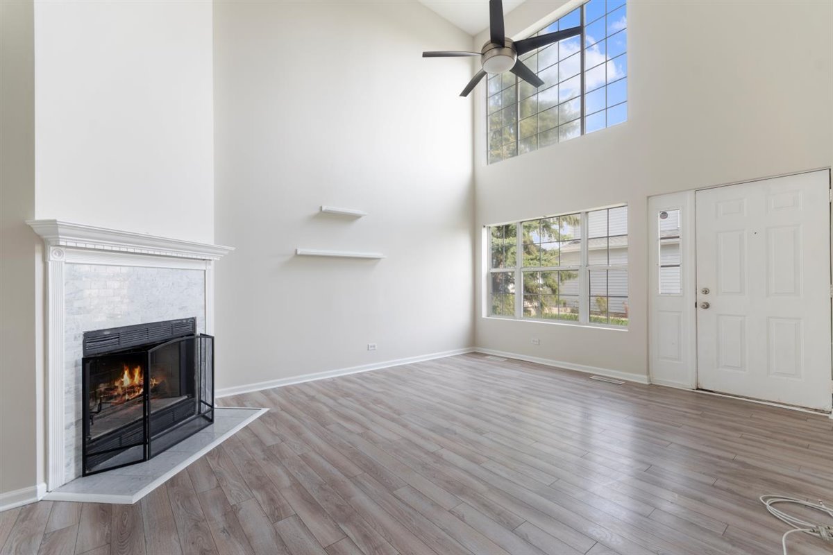 1171 Longford Road Bartlett, IL 60103 - Photo 3 of 22 a view of empty room with wooden floor and fireplace