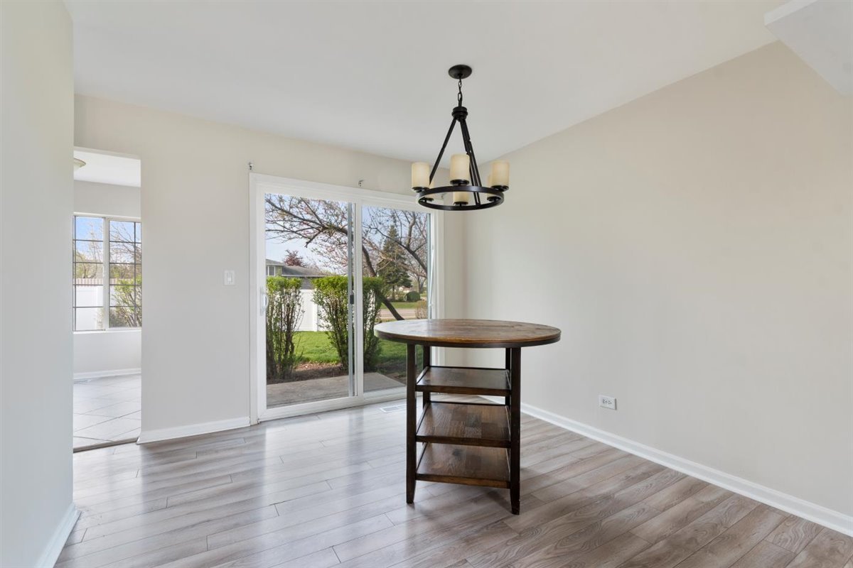 1171 Longford Road Bartlett, IL 60103 - Photo 4 of 22 a view of a hallway with wooden floor and staircase