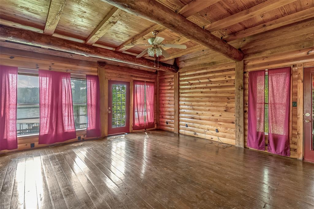 223 Razorback Lane Homer, LA 71040 - Photo 13 of 37 a view of an empty room with wooden floor and a window