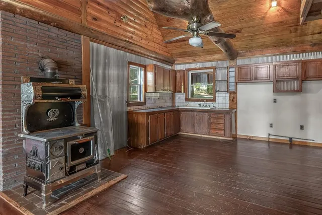a view of a kitchen with a sink cabinets and a fireplace