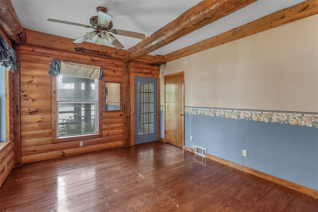 223 Razorback Lane Homer, LA 71040 - Photo 23 of 37 a view of an empty room with a window and wooden floor