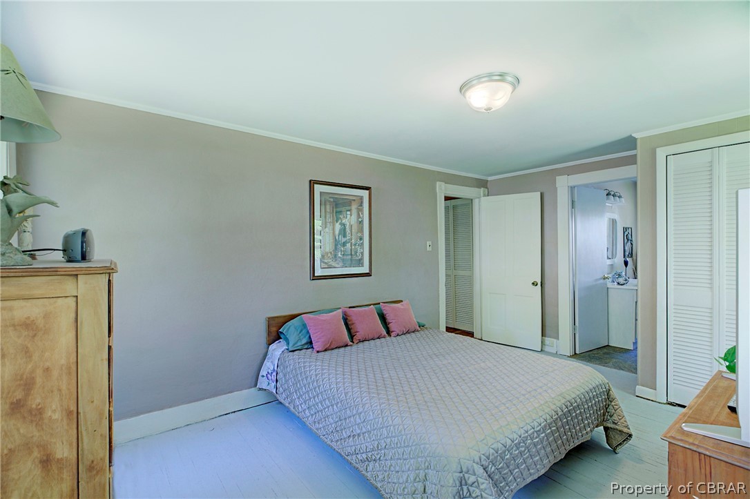 2442 Old Ferry Road Hudgins, VA 23076 - Photo 17 of 33 Bedroom featuring ornamental molding and wood-type flooring