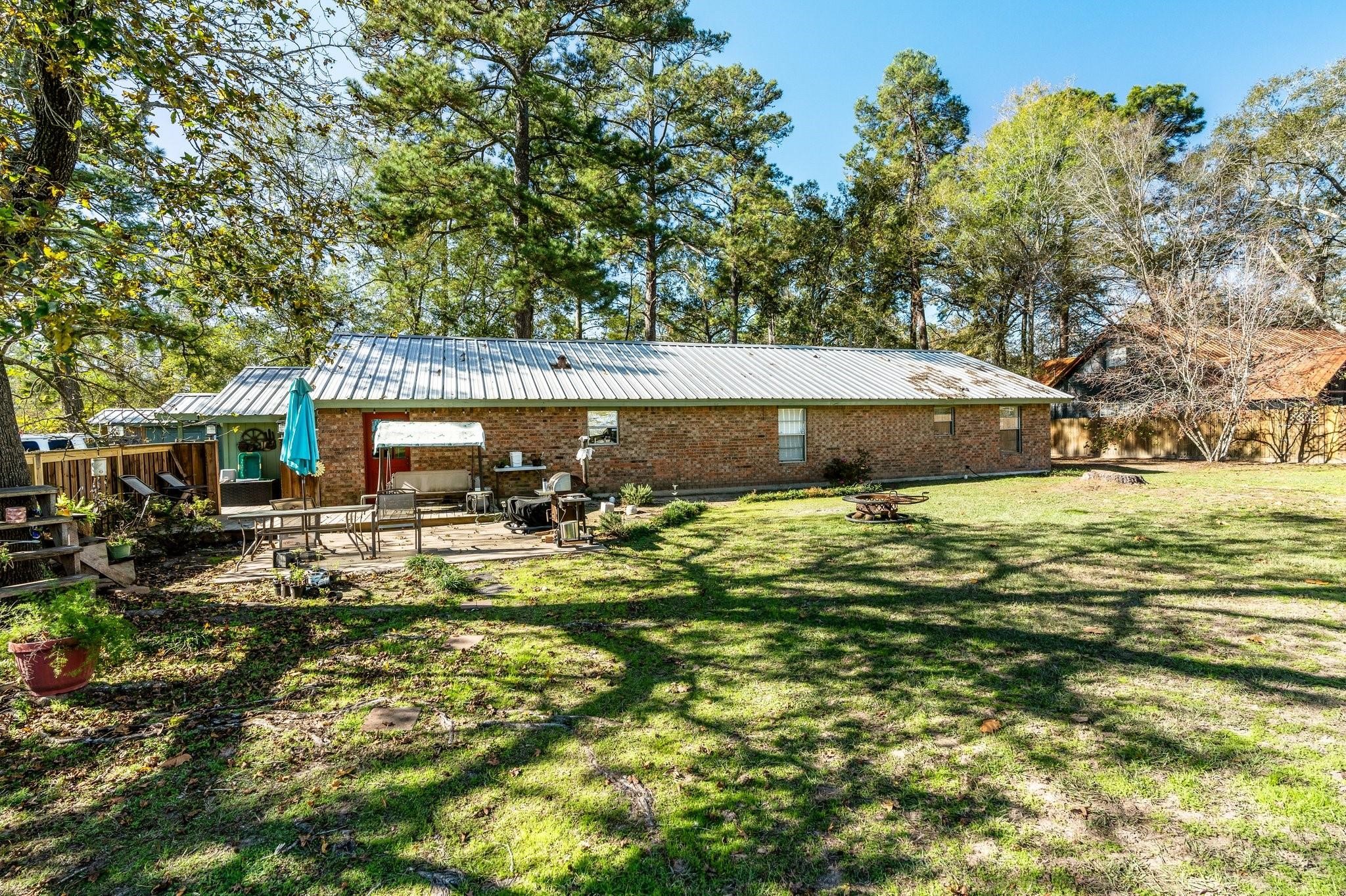 15091 Farm To Market 1485 Conroe, TX 77306 - Photo 21 of 28 a view of a swimming pool with lawn chairs and plants