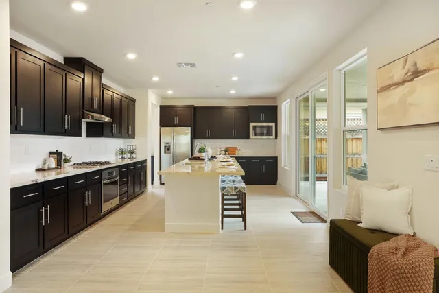 a large kitchen with stainless steel appliances kitchen island granite countertop a large counter top stainless steel appliances and cabinets