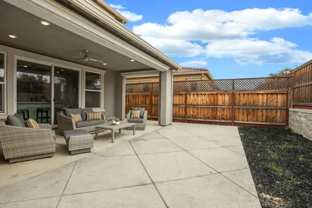 a view of a patio with couches and potted plants