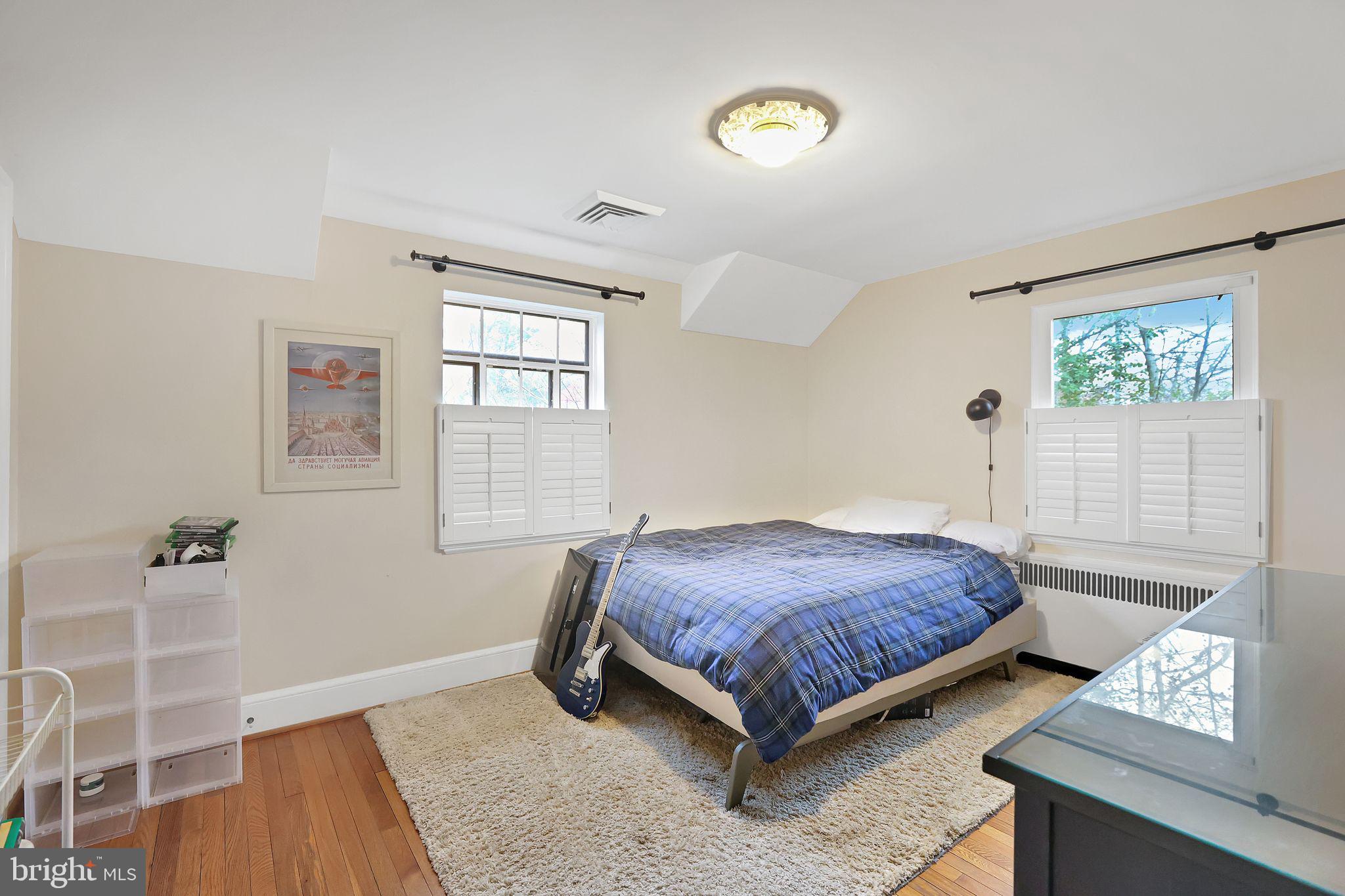 8510 Woodhaven Boulevard Bethesda, MD 20817 - Photo 13 of 18 a bedroom with a bed and a window