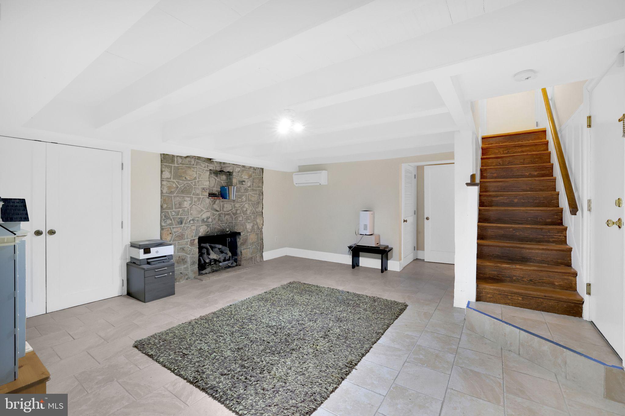 8510 Woodhaven Boulevard Bethesda, MD 20817 - Photo 16 of 18 a living room with furniture and a fireplace