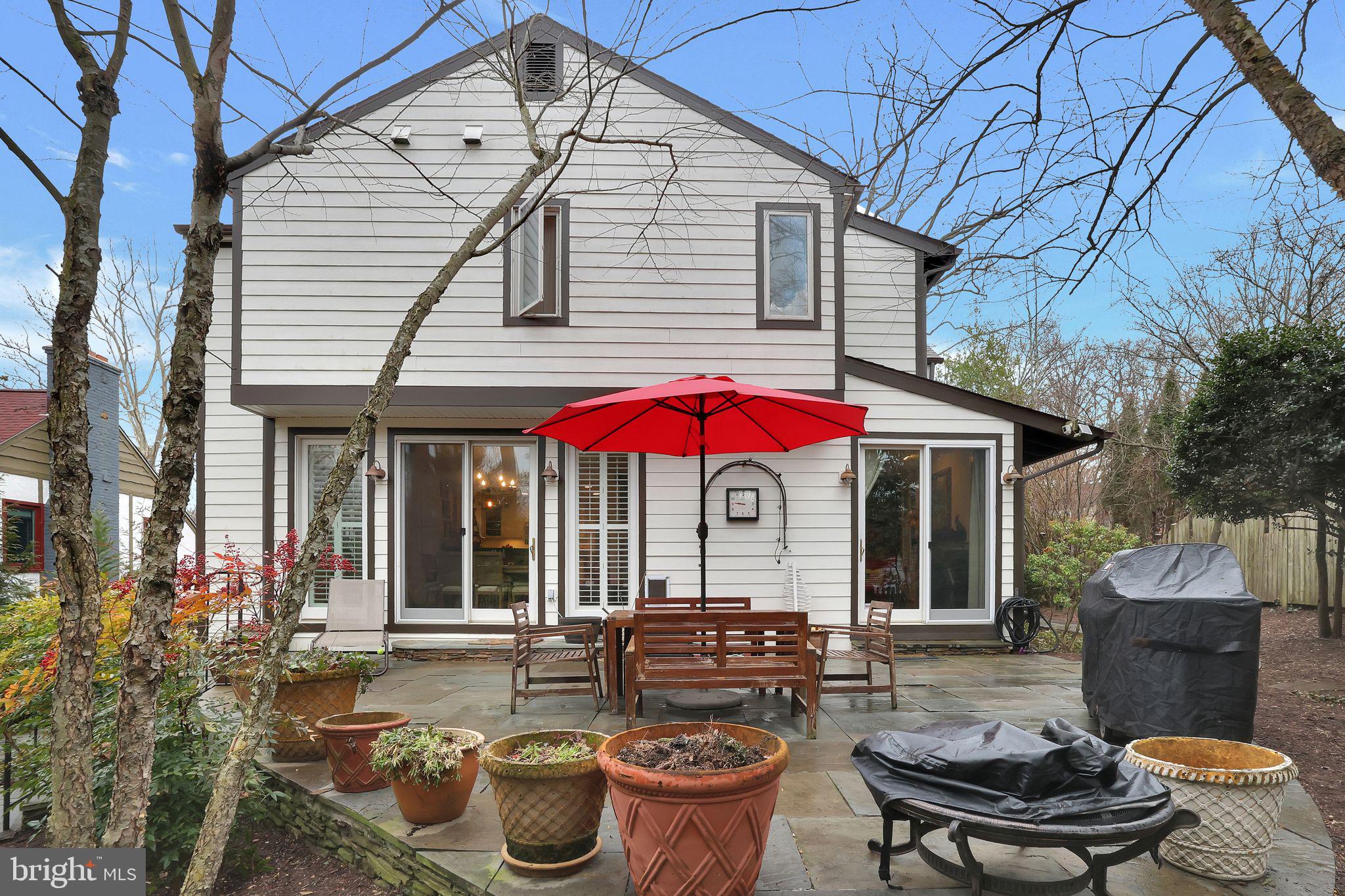 8510 Woodhaven Boulevard Bethesda, MD 20817 - Photo 18 of 18 a patio with a table and chairs under an umbrella