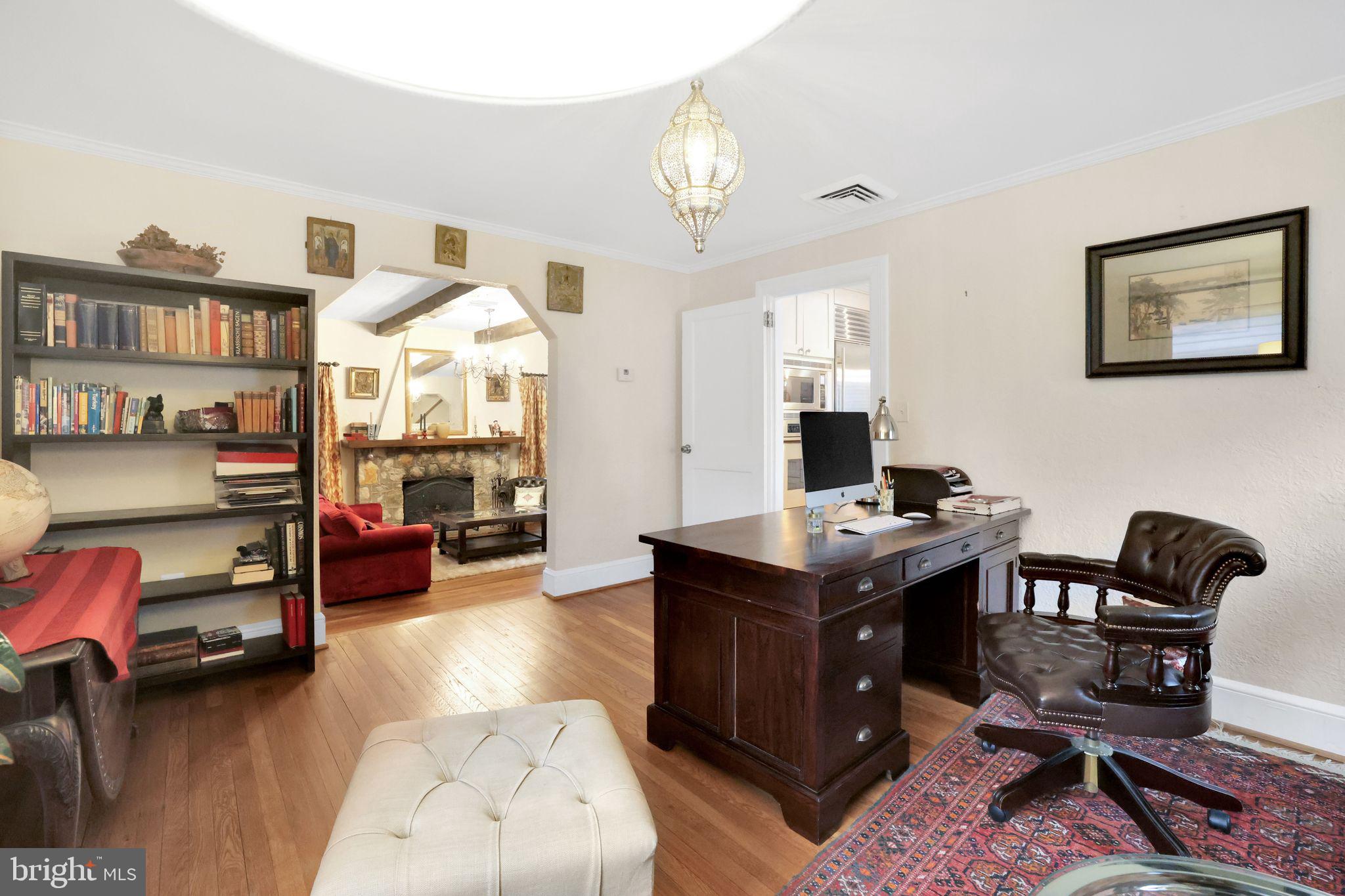 8510 Woodhaven Boulevard Bethesda, MD 20817 - Photo 4 of 18 a view of a workspace with furniture and a livingroom