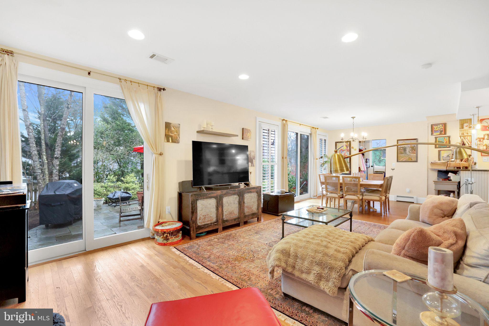 8510 Woodhaven Boulevard Bethesda, MD 20817 - Photo 8 of 18 a living room with furniture and a flat screen tv