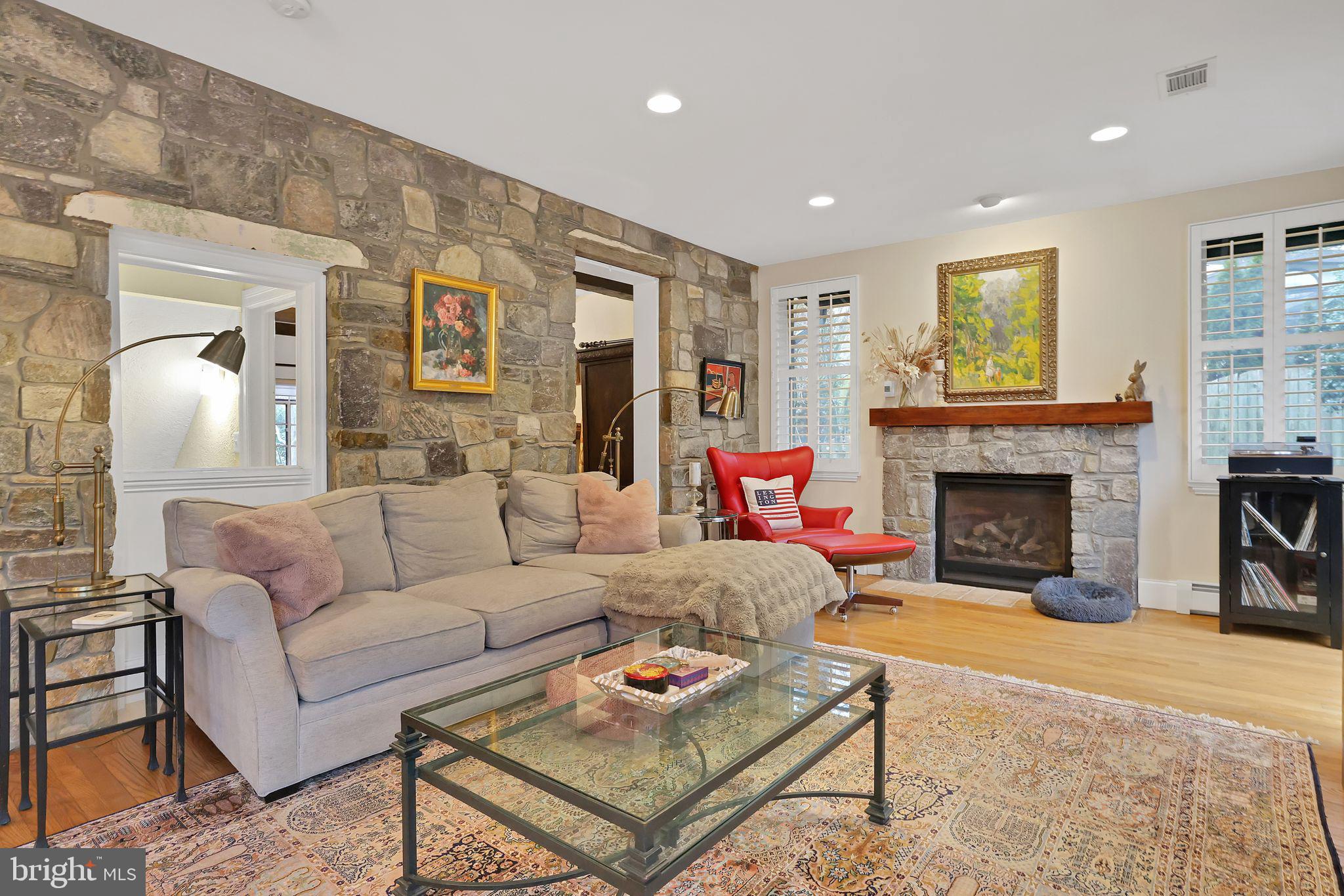 8510 Woodhaven Boulevard Bethesda, MD 20817 - Photo 9 of 18 a living room with furniture and a fireplace