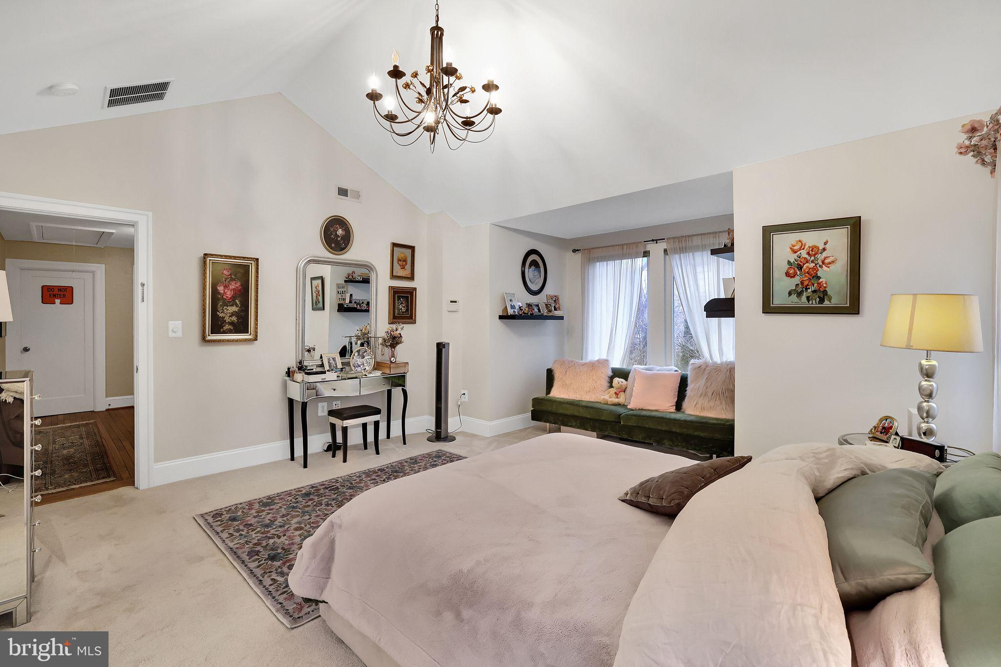 8510 Woodhaven Boulevard Bethesda, MD 20817 - Photo 10 of 18 a bedroom with a bed furniture and paintings on wall