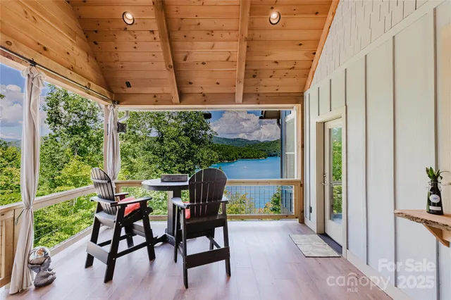 a patio with table and chairs and potted plants