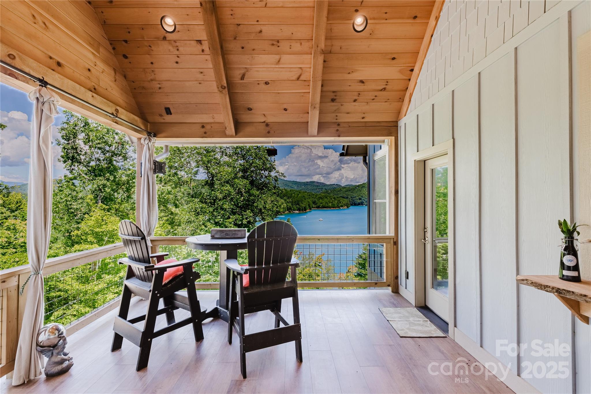216 Alarka Point Bryson City, NC 28713 - Photo 14 of 47 a patio with table and chairs and potted plants