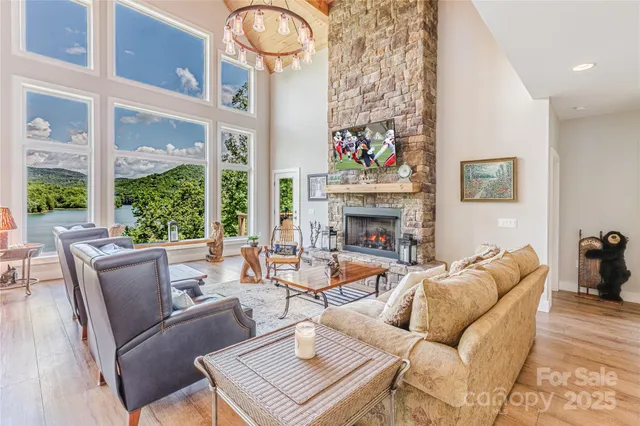 a living room with furniture a fireplace and a large window