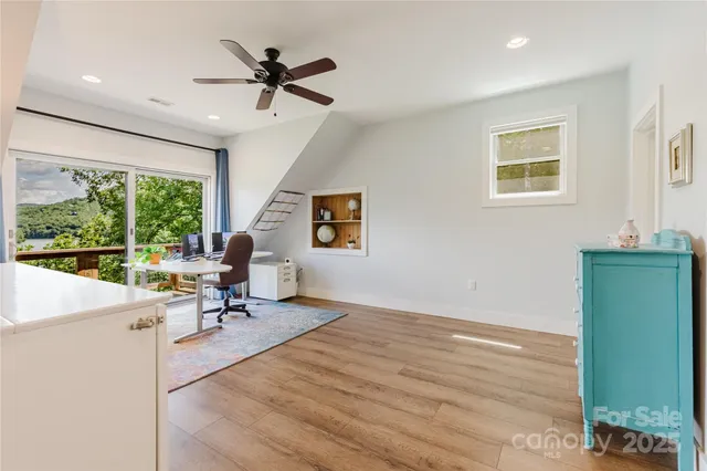 a view of a livingroom with workspace and a window
