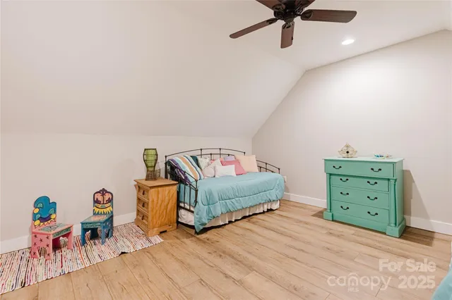 a bedroom with furniture and a wooden floor