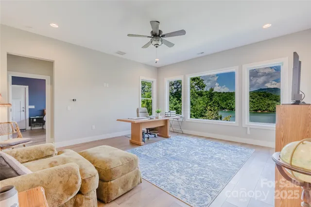 a spacious bedroom with a bed and a chandelier