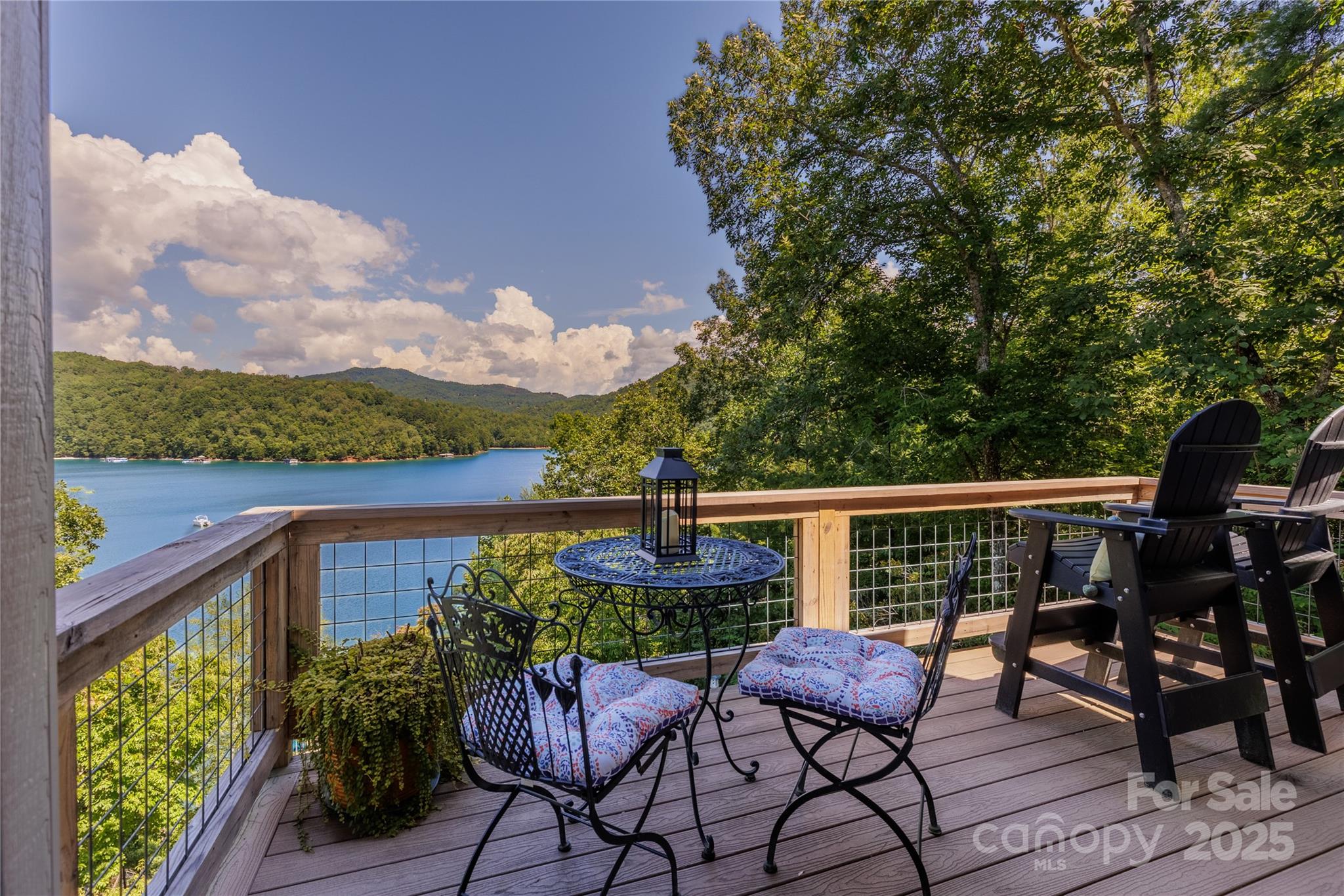 216 Alarka Point Bryson City, NC 28713 - Photo 3 of 47 a balcony with wooden floor table and chairs
