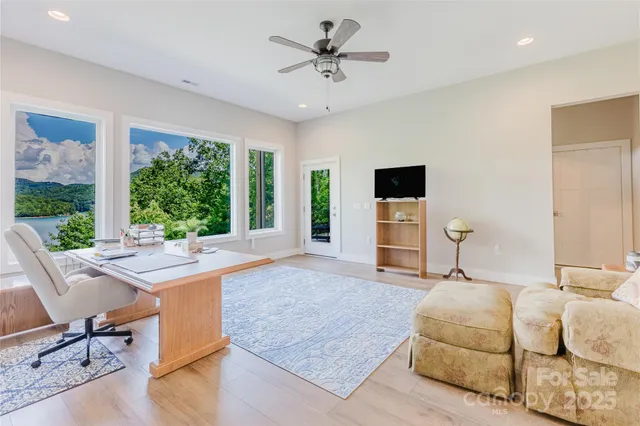 a bedroom with furniture and a large window