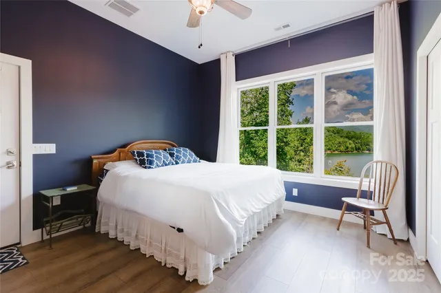 a bedroom with a bed and a large window