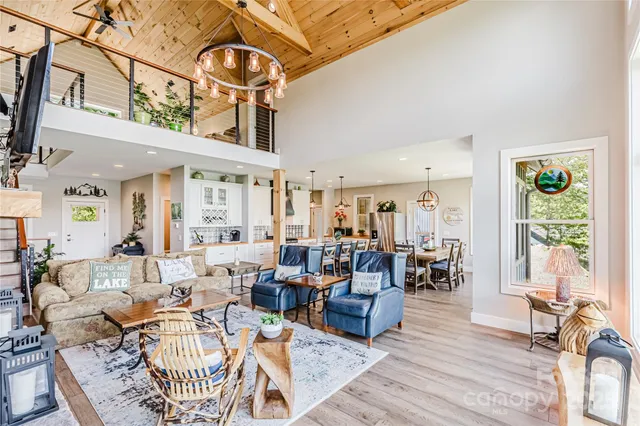 a living room with furniture a rug and a large window