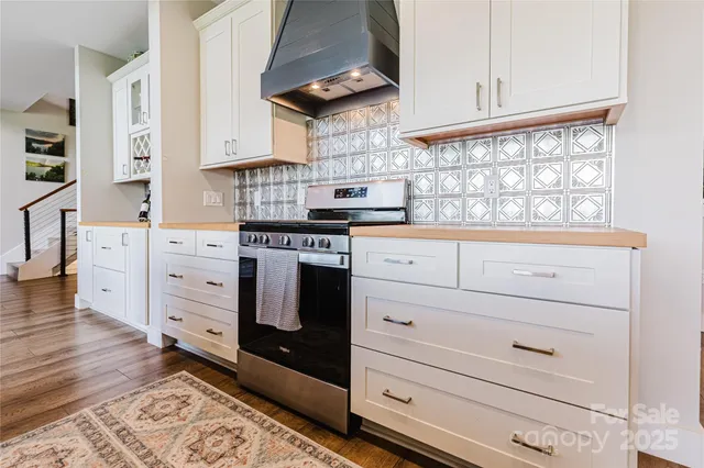 a kitchen with cabinets appliances and a window