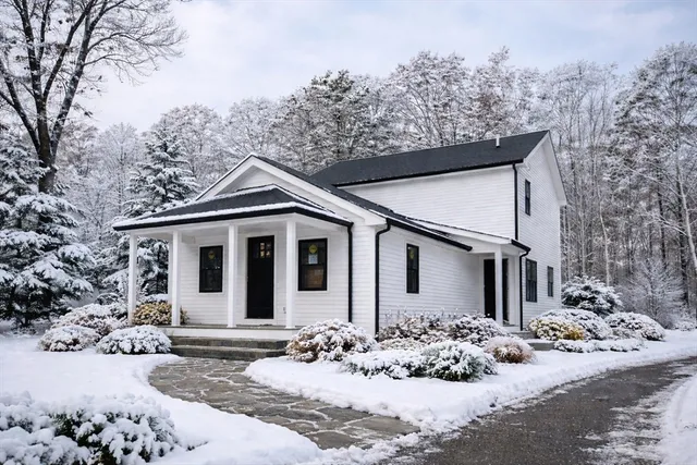 a view of a house with a yard covered in snow