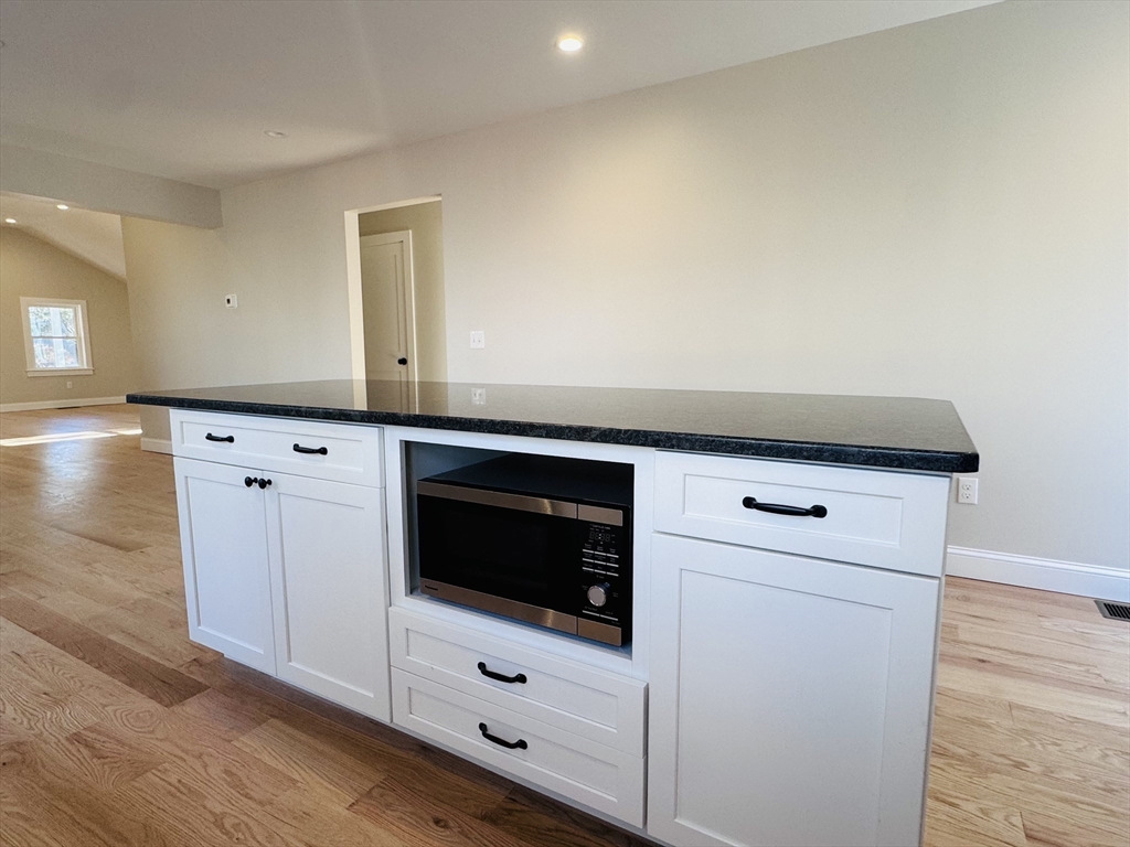 329 Tickle Road Westport, MA 02790 - Photo 11 of 42 a kitchen with granite countertop white cabinets and white appliances