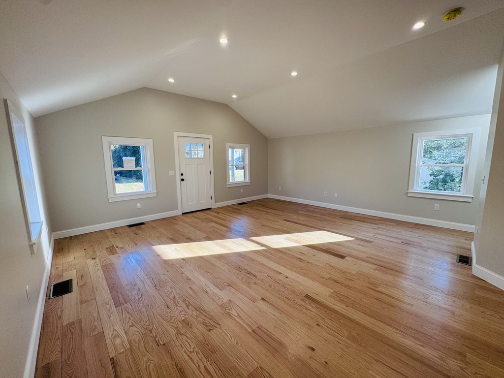329 Tickle Road Westport, MA 02790 - Photo 15 of 42 an empty room with wooden floor and windows
