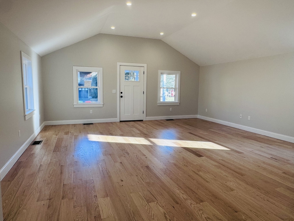 329 Tickle Road Westport, MA 02790 - Photo 16 of 42 an empty room with wooden floor and windows