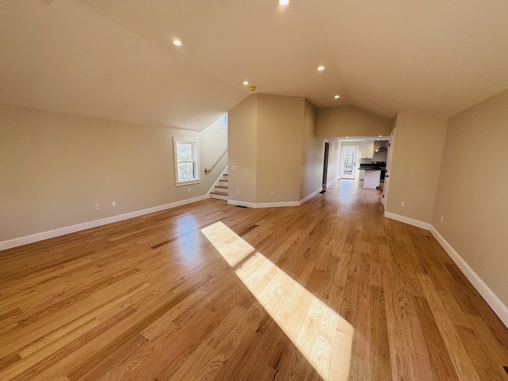 329 Tickle Road Westport, MA 02790 - Photo 19 of 42 a view of a living room with wooden floor and kitchen view